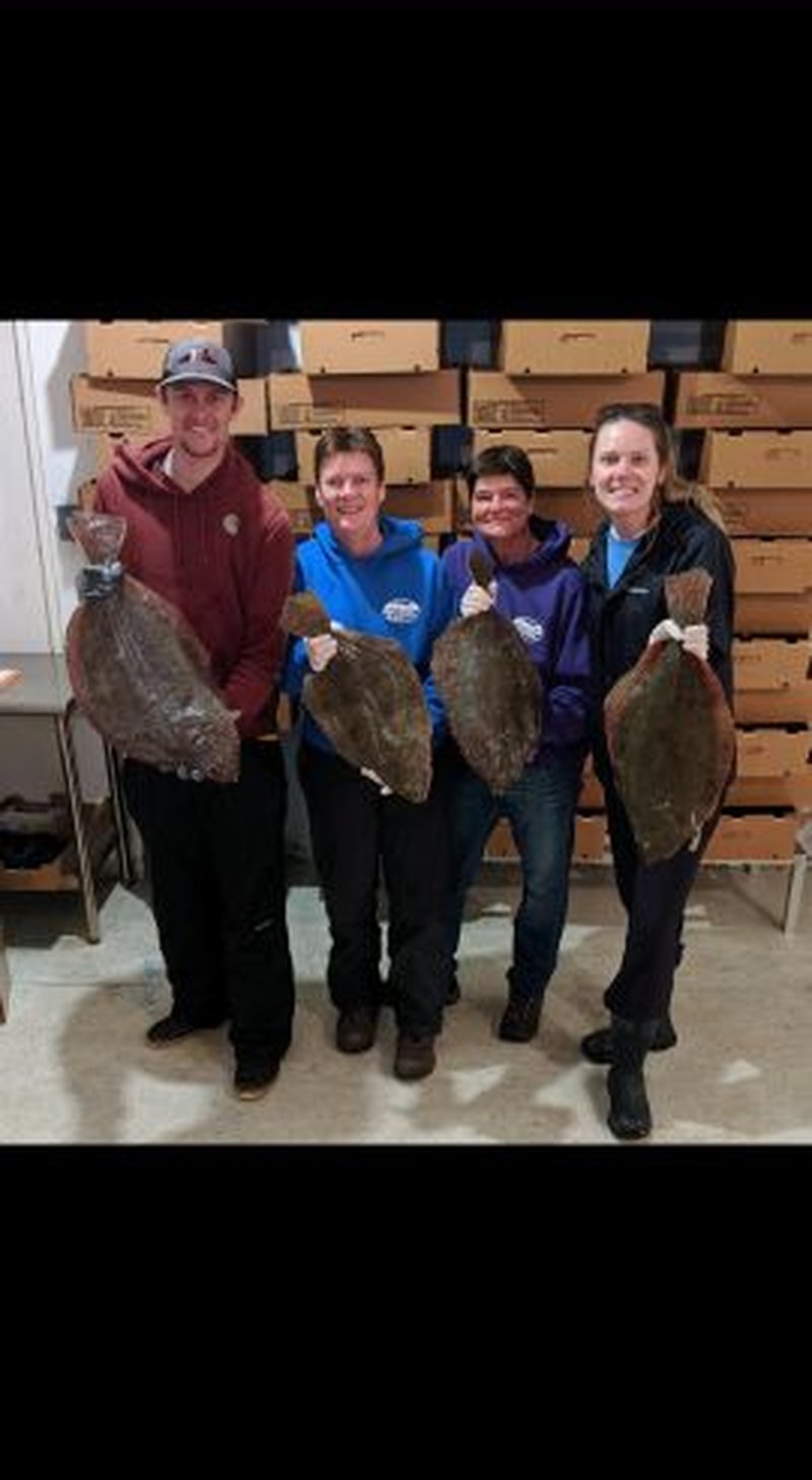 Team holding fresh flounder